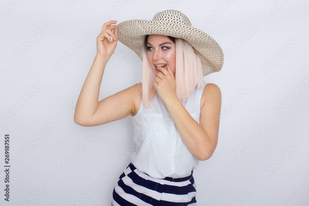 Young blonde woman with big white summer hat Young blonde woman with big white summer hat