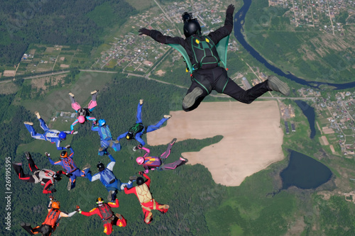 Skydiving. A cameraman makes photo and video about free falling skydivers.