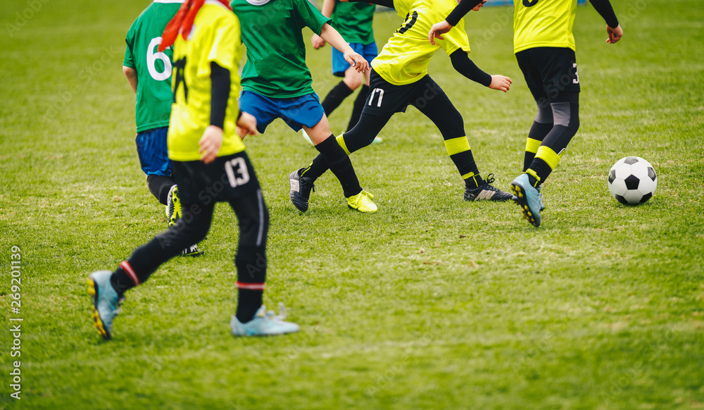 Soccer background. Players kicking soccer ball on green field. Football tournament match game for youth teams Soccer background. Players kicking soccer ball on green field. Football tournament match game for youth teams