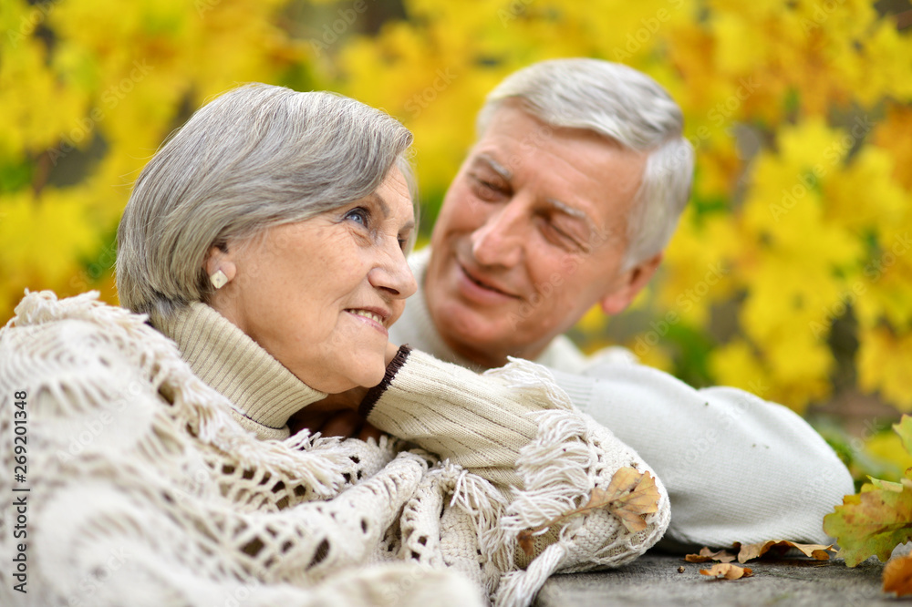 Portrait of elderly couple at table in forest Portrait of elderly couple at table in forest