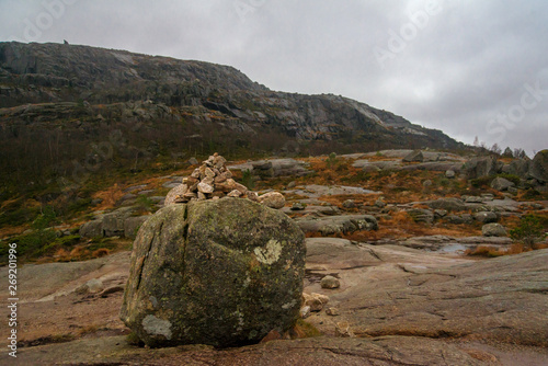 Gloomy, foggy day in Preikestolen, Norway. Beautiful landscape of rocky mountains. Pyramid of stones photo