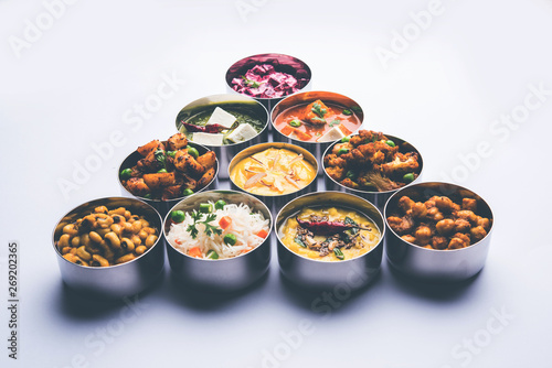 assorted Indian/Pakistani food in stainless steel bowls creating pattern or design, selective focus
