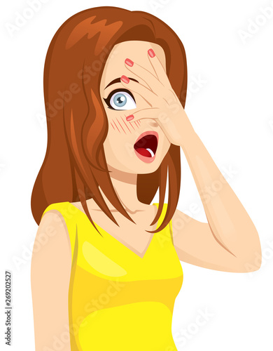 Shy teen girl covering her face with hand peeking through fingers