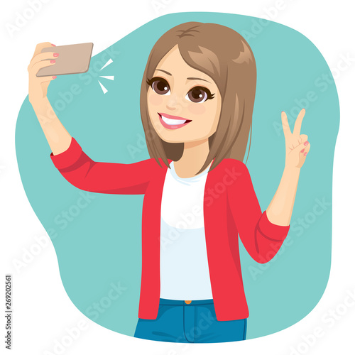Young teen girl taking selfie making victory hand sign gesture posing