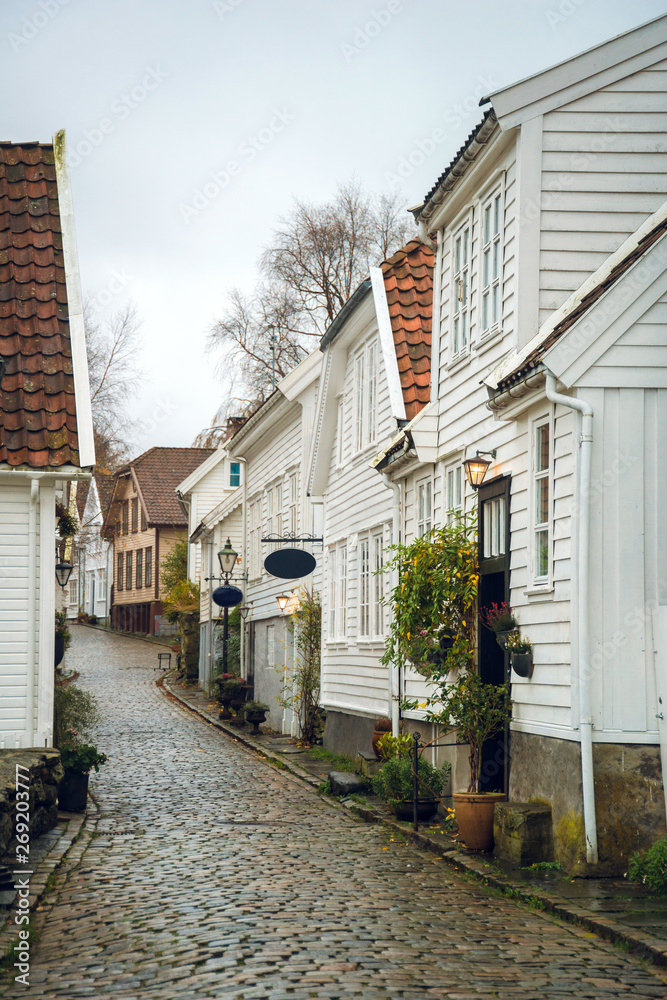Beautiful street with traditional white wooden houses in Stavanger, Norway. Summer