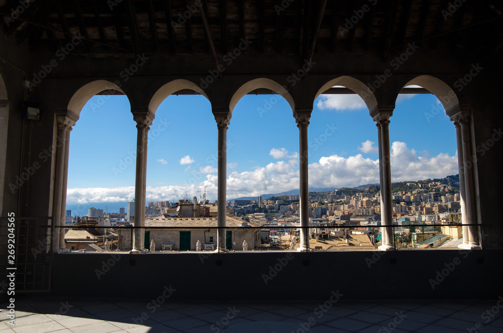 City of Genoa through the colonnade of the Saint Lawrence (San Lorenzo) Cathedral, Genoa, Italy.