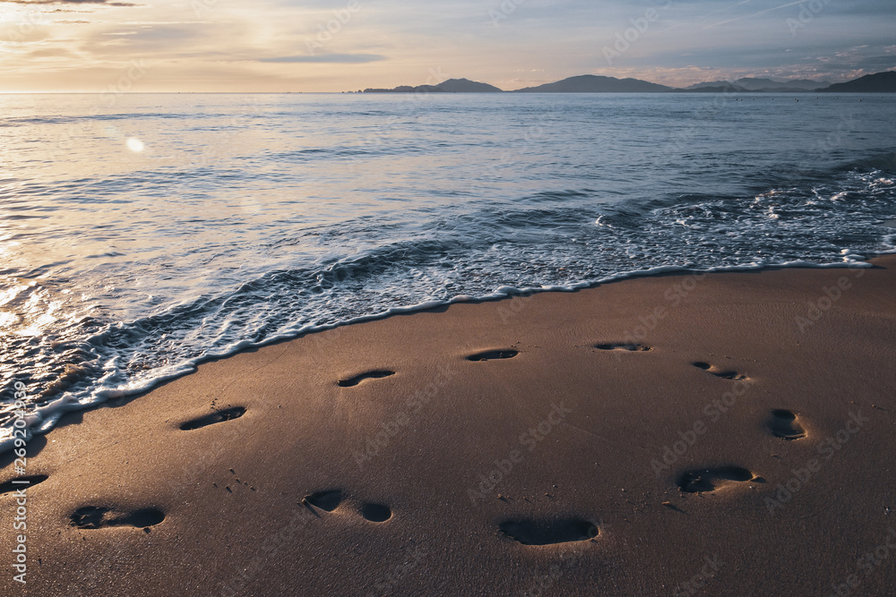 footprints in the sand from the feet of a lost person. no way out of the situation. return to the be