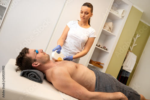 Man receiving hair removal cosmetology procedure