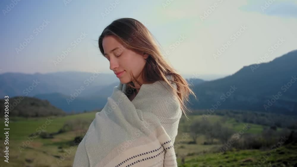 Joyful charming young female wrapping up in organic plaid and protected from country wind, cheerful emotions and lonely freedom feeling at wonderful Europe nature, portrait of no make-up smiling girl Joyful charming young female wrapping up in organic plaid and protected from country wind, cheerful emotions and lonely freedom feeling at wonderful Europe nature, portrait of no make-up smiling girl