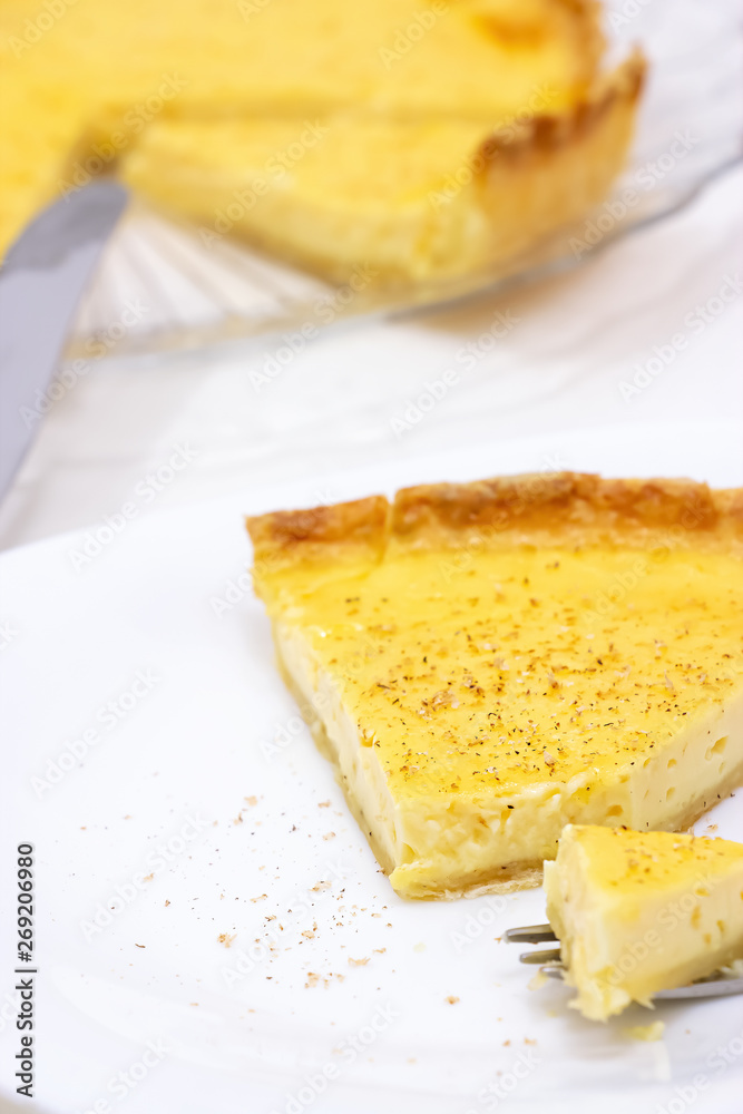 Sweet custard tart or lemon pie white background. Selective focus. Close up.