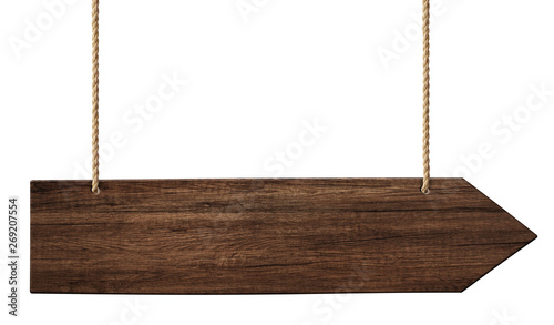 Simple wooden arrow signpost made of dark wood hanging on ropes