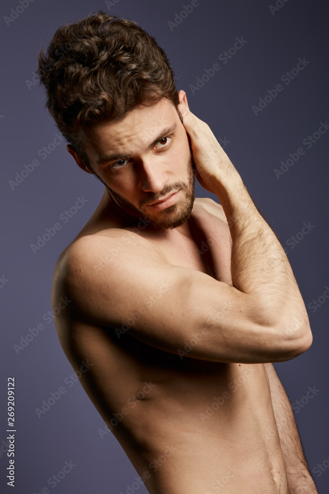 shirtless attractive serious man checking his face, skin care, man is going to shave his beard, close up photo. isolated black background shirtless attractive serious man checking his face, skin care, man is going to shave his beard, close up photo. isolated black background