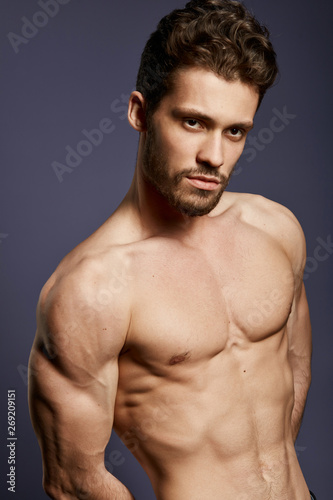 Muscular torso of young handsome man. close up portrait, isolated black background. wellness, health and body care