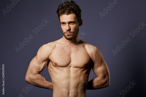 awesome sportsman showing his perfect, ideal abdorminal musculars in the studio. close up portrait, wellness, wellbeing