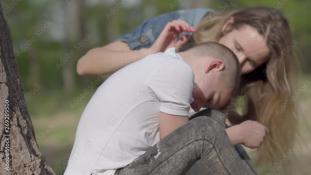 Portrait small boy is crying and mother is soothing her son outdoors. Relationship mom and son. Outdoor recreation. Portrait small boy is crying and mother is soothing her son outdoors. Relationship mom and son. Outdoor recreation.