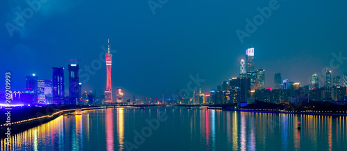 Guangzhou cityscape over the Pearl River with Liede Bridge, TV Tower and financial district illuminated in the evening. Guangzhou, Southern China.