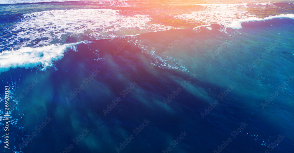 Blue water texture with wave crest with sunlight. Concept ocean background