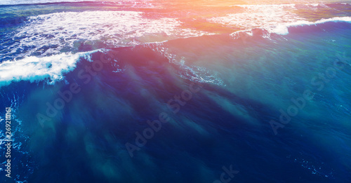 Blue water texture with wave crest with sunlight. Concept ocean background