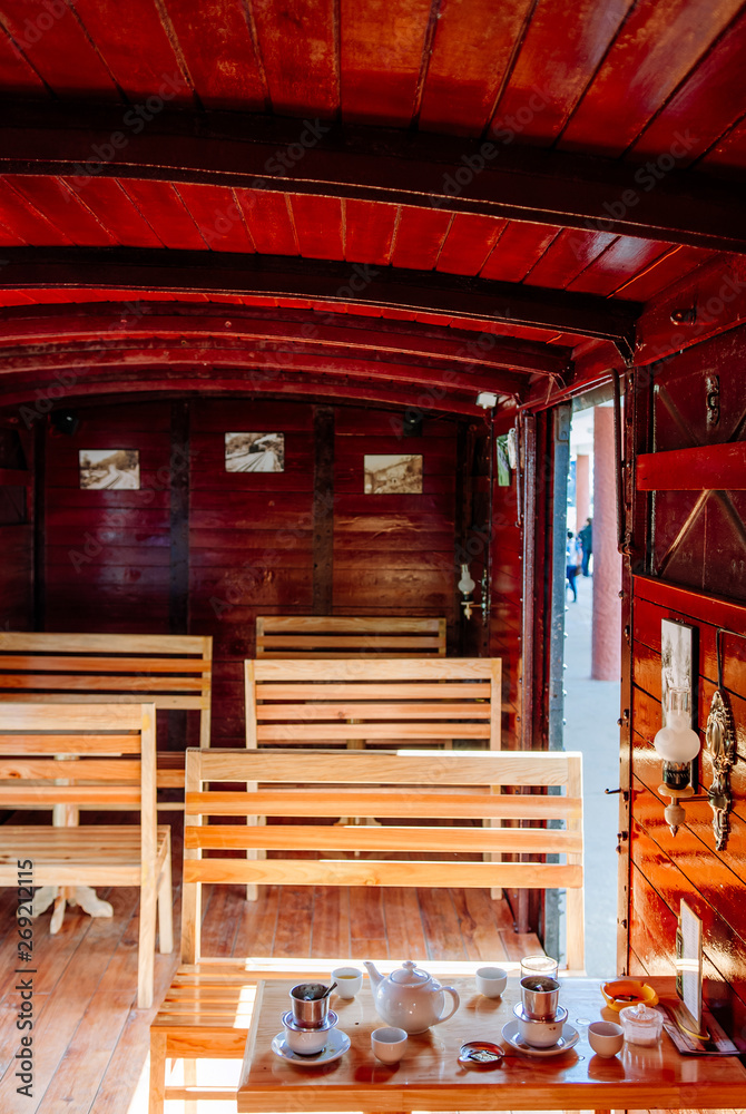 Old train car red wooden interior with seats and table Old train car red wooden interior with seats and table