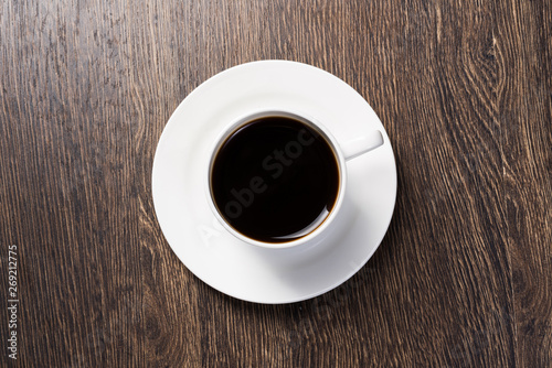 Cup of natural coffee on wooden table