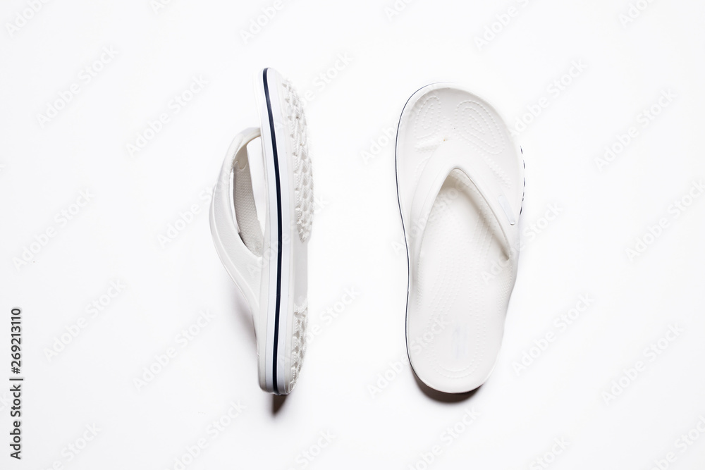 Flip flops on a white isolated background. White female flip flops.