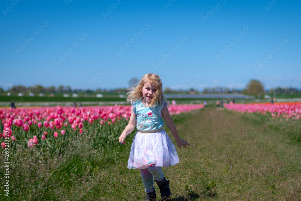 Little Girl Happy in a Tulip Field Little Girl Happy in a Tulip Field