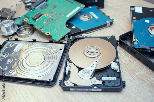 Slika na platnu old broken hard disk drives composition in a repair recovery service