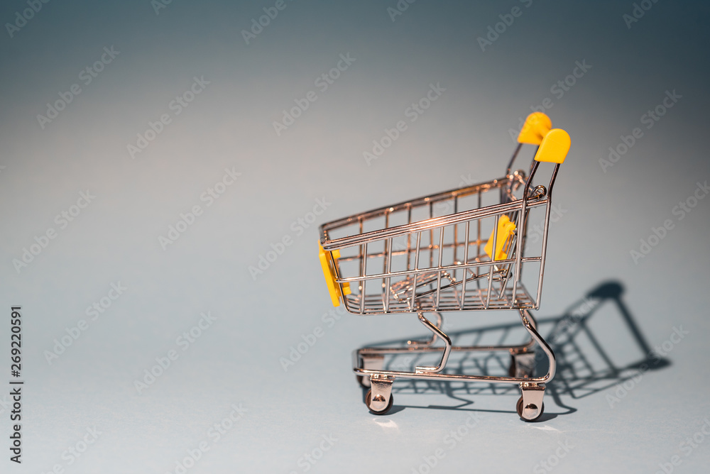 close-up of shopping carts on gray background with copy space