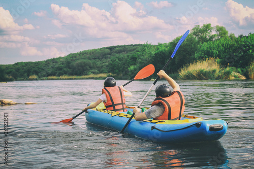 Wallpaper Mural Young couple enjoy white water kayaking on the river, extreme and fun sport at tourist attraction. Rafting on the  Pivdennyi Buh River. Active adventure couple along the river Torontodigital.ca