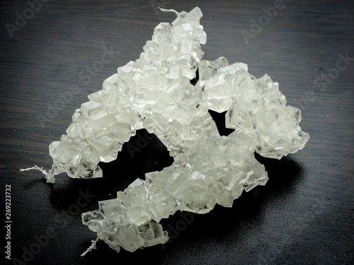 White nabat with black background , Iranian rock candy on a wooden table. photo
