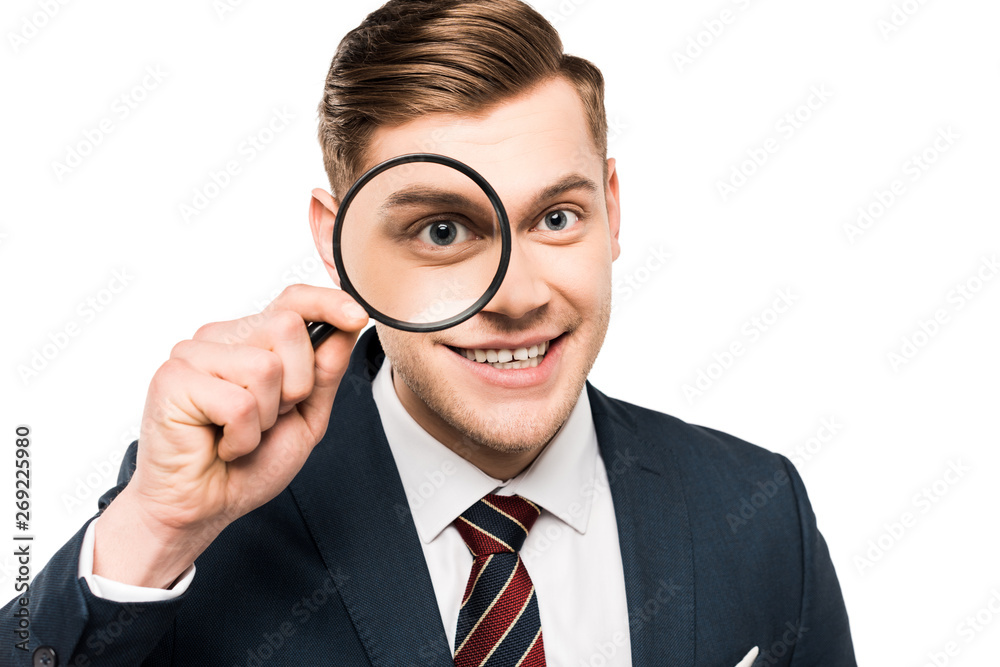cheerful businessman holding magnifying glass near eye isolated on white cheerful businessman holding magnifying glass near eye isolated on white