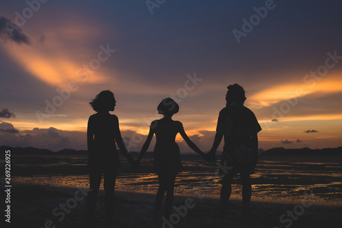 family on the beach at sunset