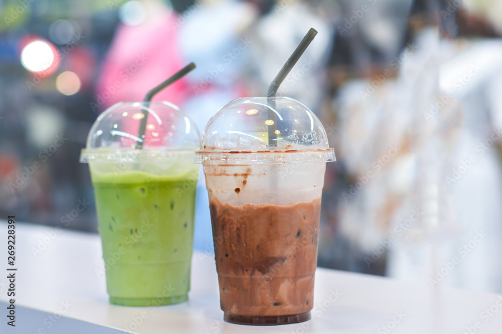 Close up ice dark cocoa with fresh milk in plastic cup to take home at coffee shop. Close up ice dark cocoa with fresh milk in plastic cup to take home at coffee shop.
