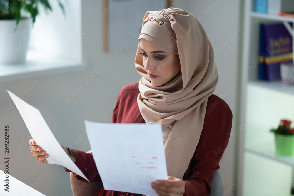 Young teacher feeling busy while preparing for the lesson Young teacher feeling busy while preparing for the lesson