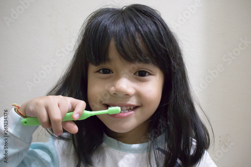 little girl smile brushing her teeth