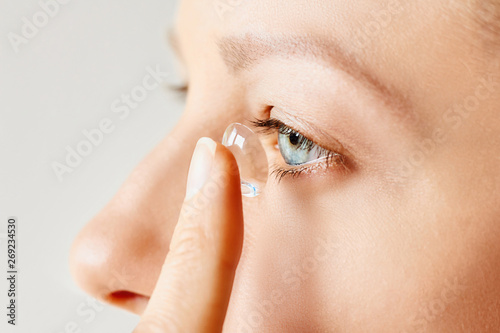 Young woman puts contact lens in her eye. Eyewear, eyesight and vision, eye care and health, ophthalmology and optometry concept, selective focus