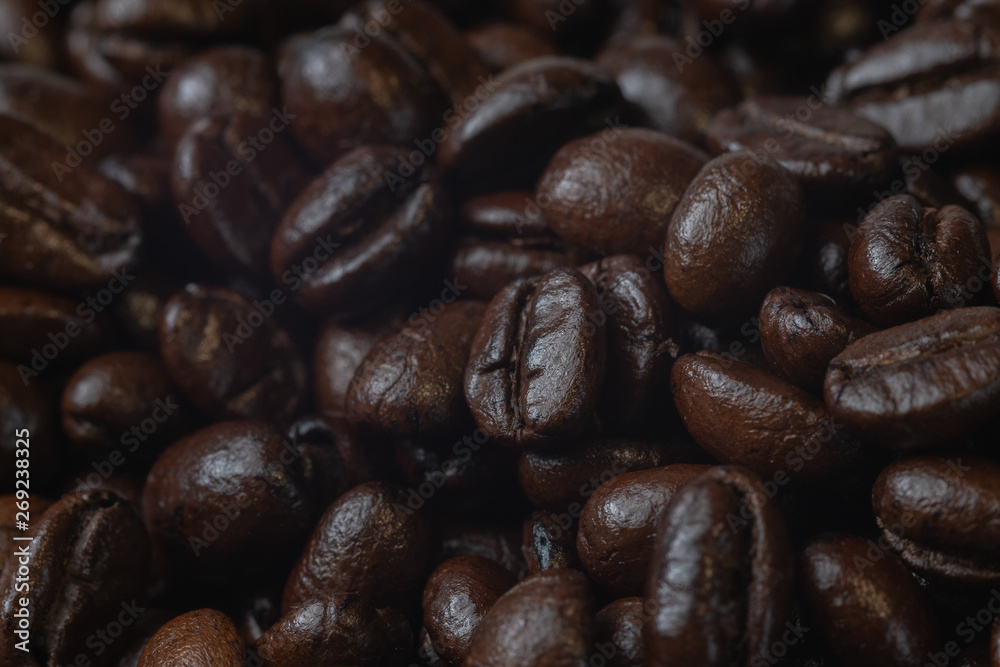 close up of pile roast coffee beans on wooden board close up of pile roast coffee beans on wooden board