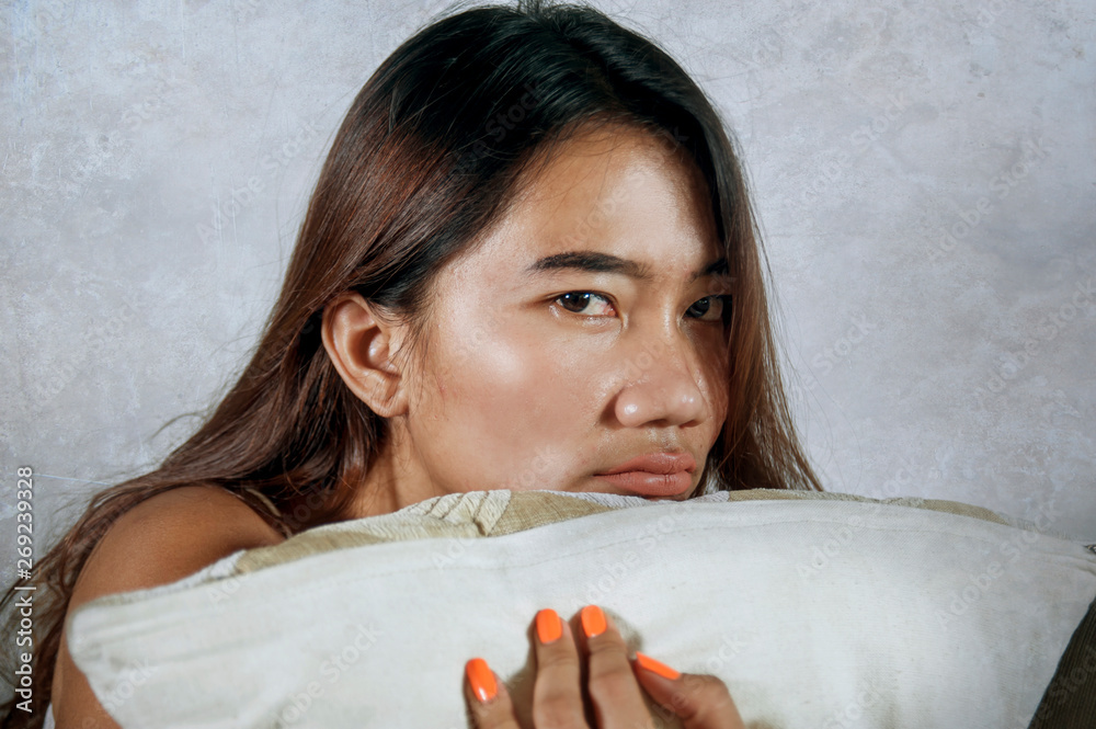young sad and depressed Asian Indonesian woman stting at home couch crying frustrated and upset suffering stress and depression after breakup young sad and depressed Asian Indonesian woman stting at home couch crying frustrated and upset suffering stress and depression after breakup