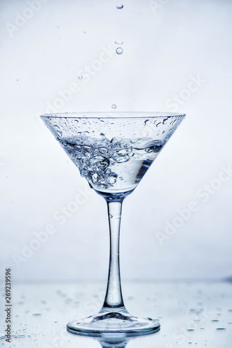 Martini glass with frozen splashing drops of drink