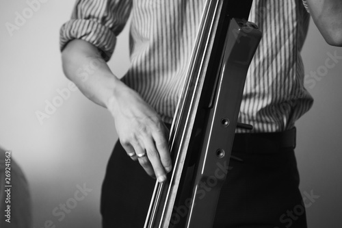 Man plays modern electric contrabass photo