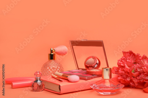 Beautiful composition with coral beauty accessories, notebook and flowers on color background