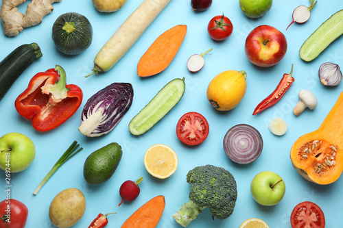 Flat lay composition with fresh ripe vegetables and fruits on color background photo