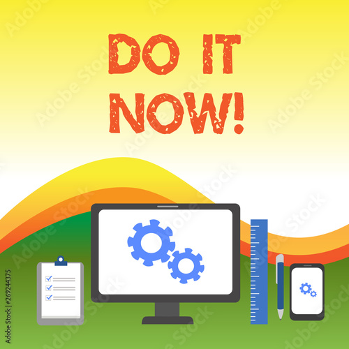 Text sign showing Do It Now. Business photo text not hesitate and start working or doing stuff right away Business Concept PC Monitor Mobile Device Clipboard Ruler Ballpoint Pen