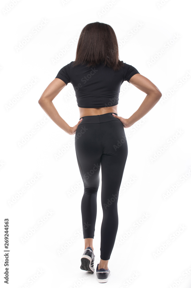 back view of young black woman in sportswear on white background. 
