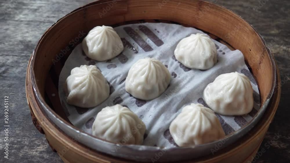Eating Chinese Dim Sum Dumplings in Bamboo Steamer with Chopsticks. Top View Eating Chinese Dim Sum Dumplings in Bamboo Steamer with Chopsticks. Top View