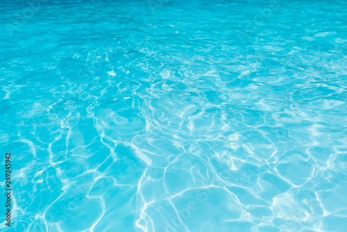 Wonderful blue and bright ripple water and surface in swimming pool  Beautiful motion gentle wave in pool for blue abstract or nature background