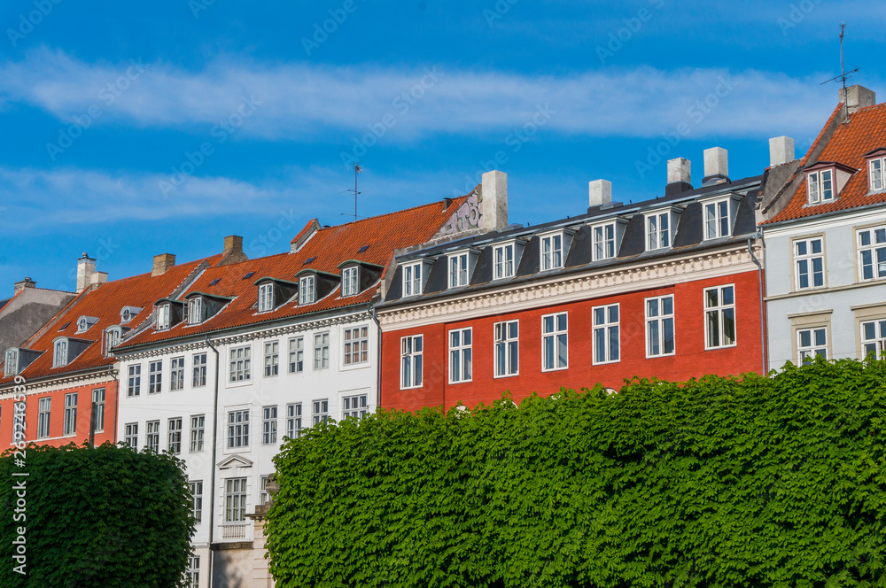 Scenic summer view of the ancient classic colorful houses with blue sky in Copenhagen, Denmark