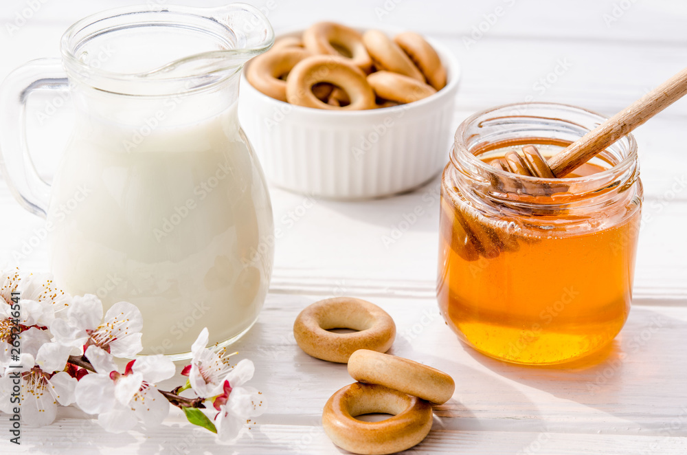 Useful snack from fresh flower sweet honey, fresh milk and bagels