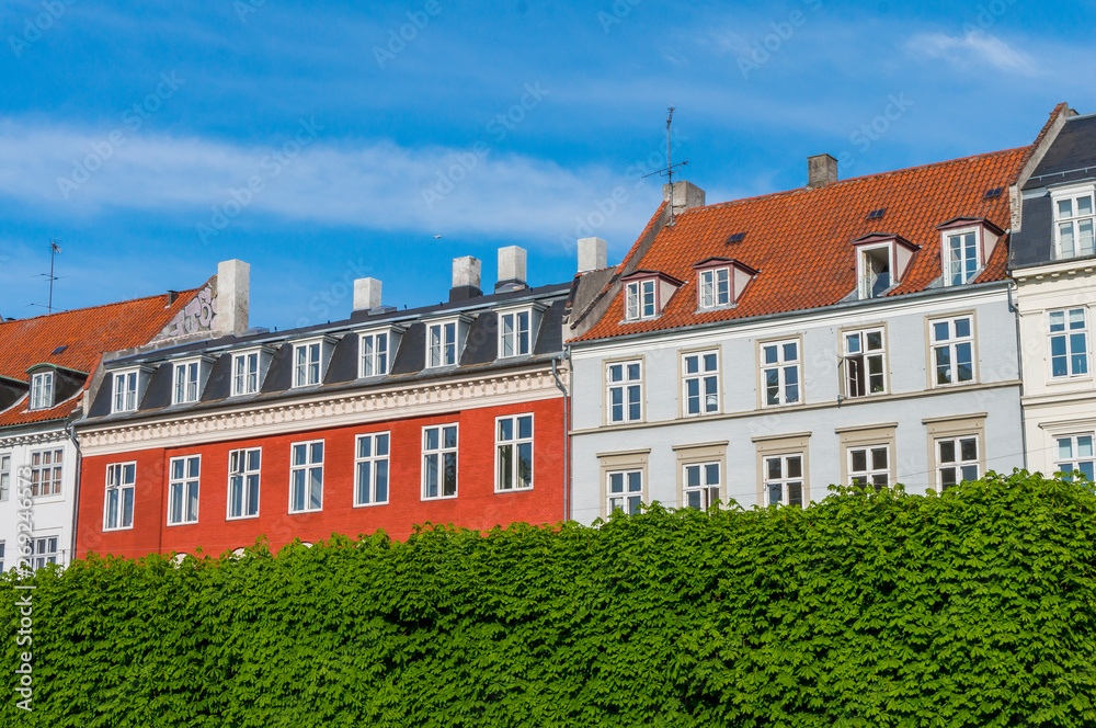 Scenic summer view of the ancient classic colorful houses with blue sky in Copenhagen, Denmark Scenic summer view of the ancient classic colorful houses with blue sky in Copenhagen, Denmark