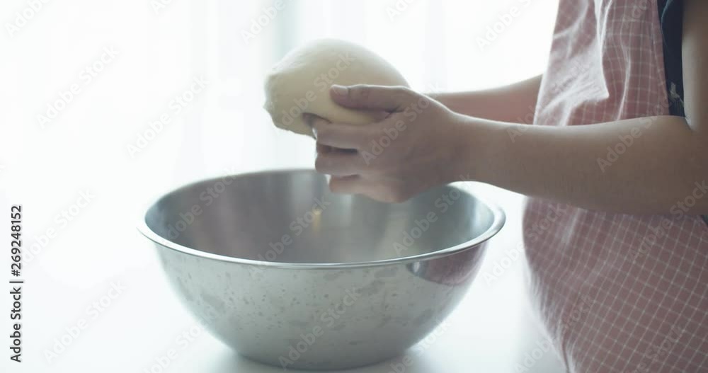 Woman kneading by hand on stainless steel bowl. Slow Motion, 4K Woman kneading by hand on stainless steel bowl. Slow Motion, 4K